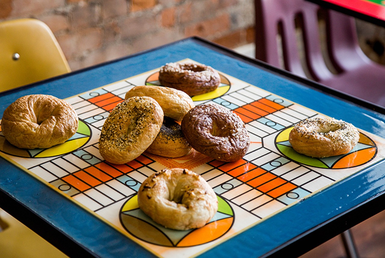 OTR Bagel Bar
107 W. Elder Street, Over-the-Rhine
This Findlay Market bagelry opened December 2018. According to our interview with the team behind OTR Bagel Bar in 2017, the space takes its decorative cue and overall ambiance from a &#147;nostalgic&#148; stance. The tables have gameboard tops &#151; &#146;80s board games are present to play &#151; and colorful chairs. A lineup of 10 standard bagels &#151; such as poppy seed, onion, everything and plain &#151; and specialty bagels like carrot cake grace the menu. They also make specialty cream cheeses, like jalape&ntilde;o and cookie dough, and bagel breakfast sandwiches. 
Photo: Hailey Bollinger
