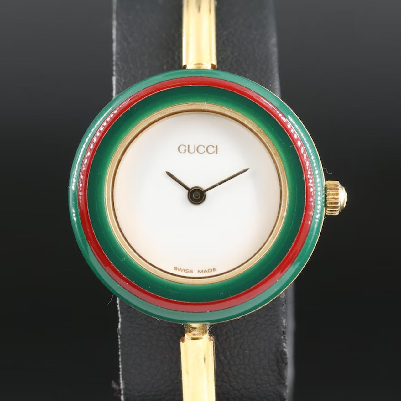 Gucci Bangle Wristwatch with Interchangeable Bezels
Father, son and house of Gucci – this bangle watch set is both timeless and trending on TikTok for its nifty interchangeable colored faces. Albeit a little beat up, the watch comes with all the original packaging, but the watch itself seems to be in great shape.