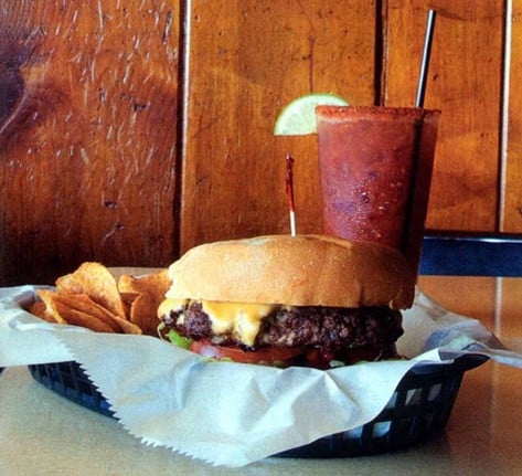 City View Tavern: Big Ted Deluxe
403 Oregon St., Mt. Adams
Who it’s named after: Ted Lagemann, the former owner of City View Tavern who legend says banned tequila from the bar after stopping Charles Manson (yep, that Charles Manson) from leaping off the establishment’s deck one night in a tequila-fueled craze.
The burger: Topped with American cheese, brown mustard, ketchup, mayo, onion, lettuce, tomato and pickle.