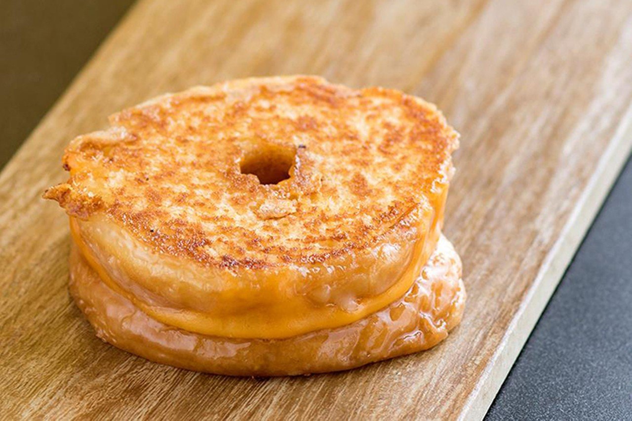 A Tom + Chee Grilled Cheese Donut
Multiple locations including 125 E. Court St., Over-the-Rhine
A gourmet grilled cheese and tomato soup shop with a famous grilled-cheese donut. With the backing of Shark Tank, founders Trew Quackenbush and Corey Ward went from a Fountain Square pop-up to a 14-state chain. They make their own dressings, sauces and spreads in-house and roast their own meats, but the dish that put them on the map was their grilled cheese donut &#151; featured on multiple TV shows including The Chew, Man v. Food Nation and TODAY.
Photo via Facebook.com/TomandChee