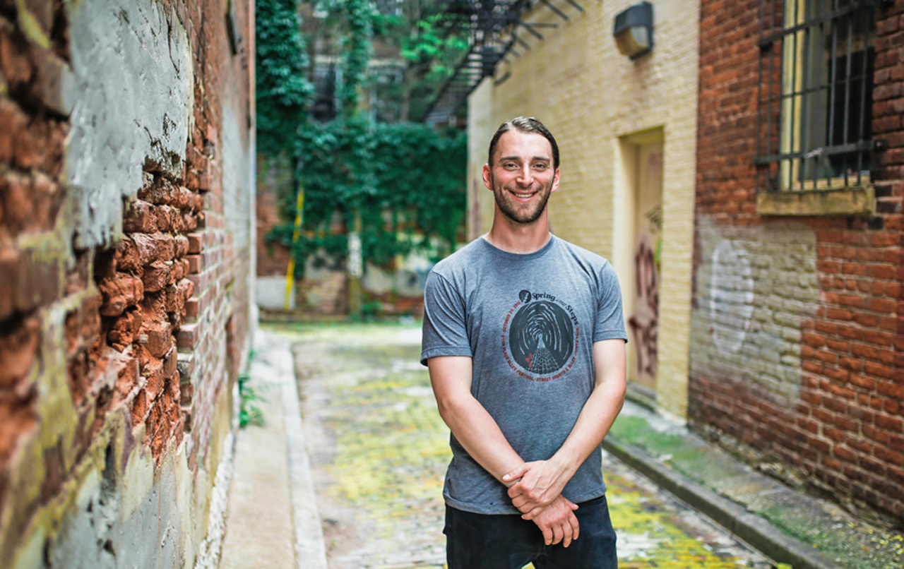 Christian Huelsman of Spring in Our Steps stands at the entrance to Over-the-Rhine's Drum Alley, which ends at Coral Alley.