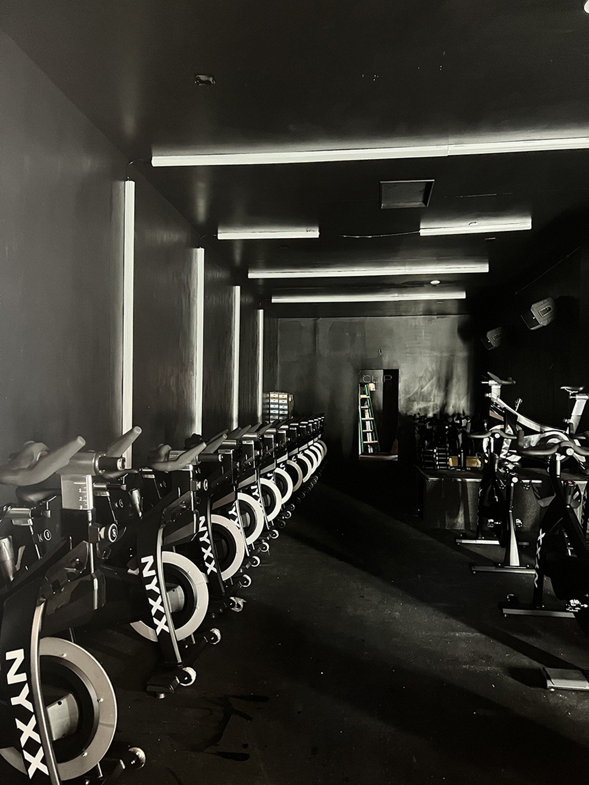 Inside of NYXX Cycle's fitness studio, two rows of cyclists look directly into a floor-to-ceiling mirror, which helps everyone remain synchronized through each round of choreography.