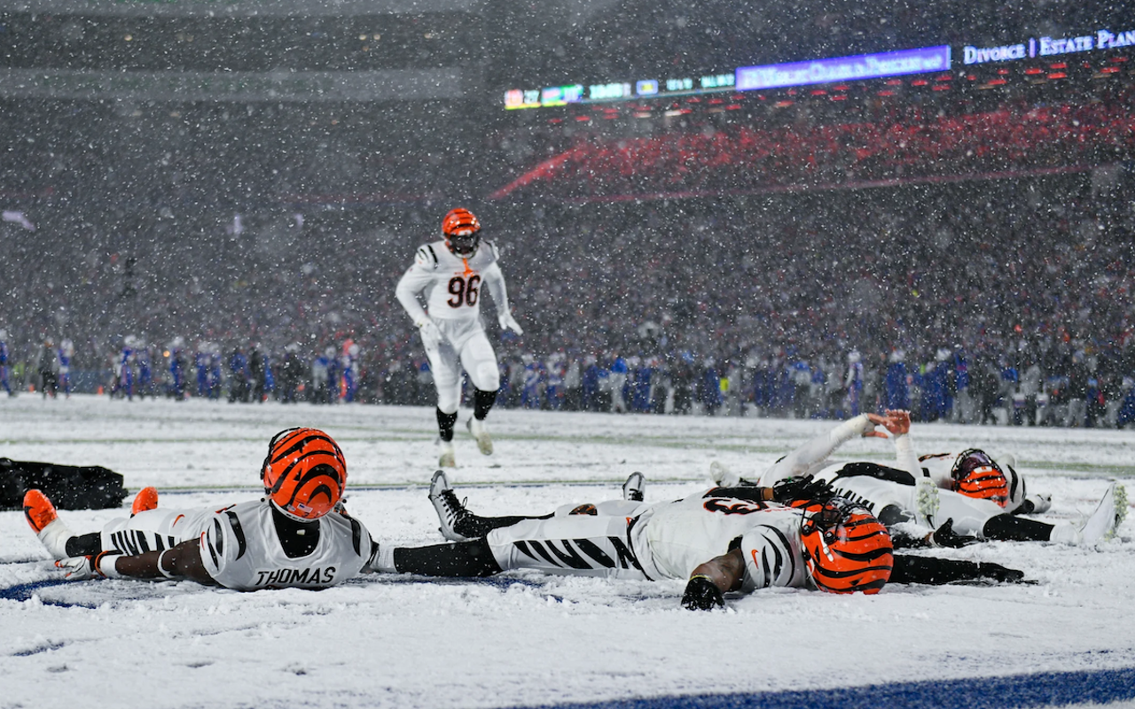 The Cincinnati Bengals celebrate an AFC divisional-round win over the Buffalo Bills by making snow angels in the end zone at Highmark Stadium on Jan. 22, 2023.