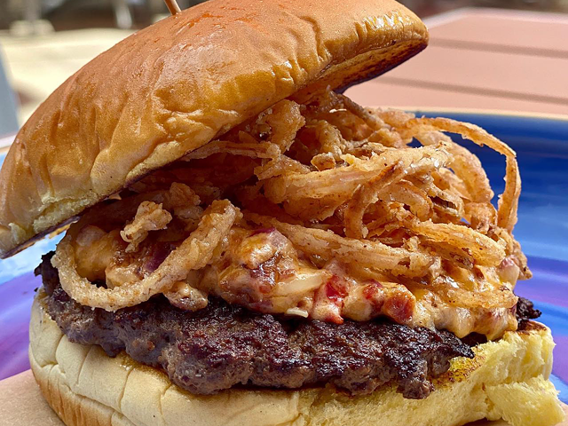 Cincinnati Burger Week burger from Butler's Pantry, topped with onion straws, bacon, pimento cheese, and root beer barbecue