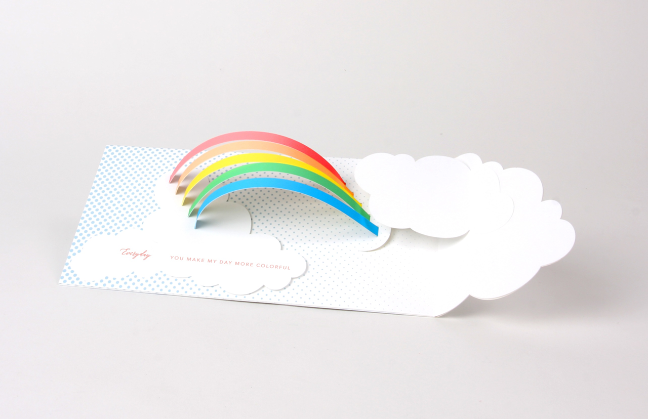 This rainbow card features pearlescent holographic foil
