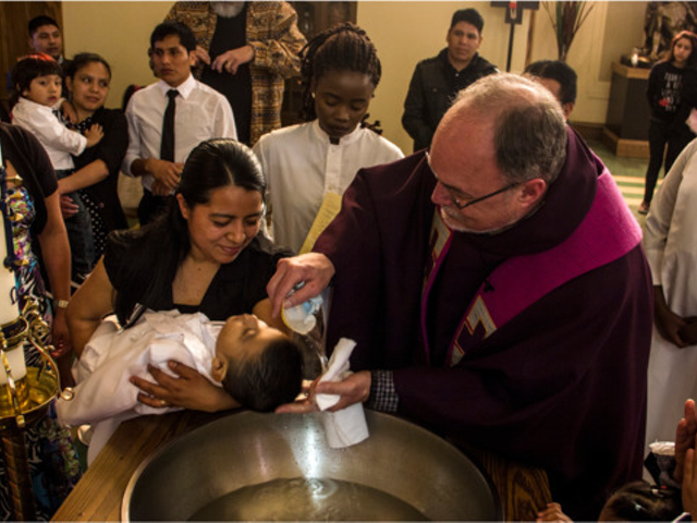 Father Jim Schutte baptizes the child of Guatemalan immigrants at St. Leo the Great Catholic Church in Cincinnati as congregants who are refugees from Burundi look on