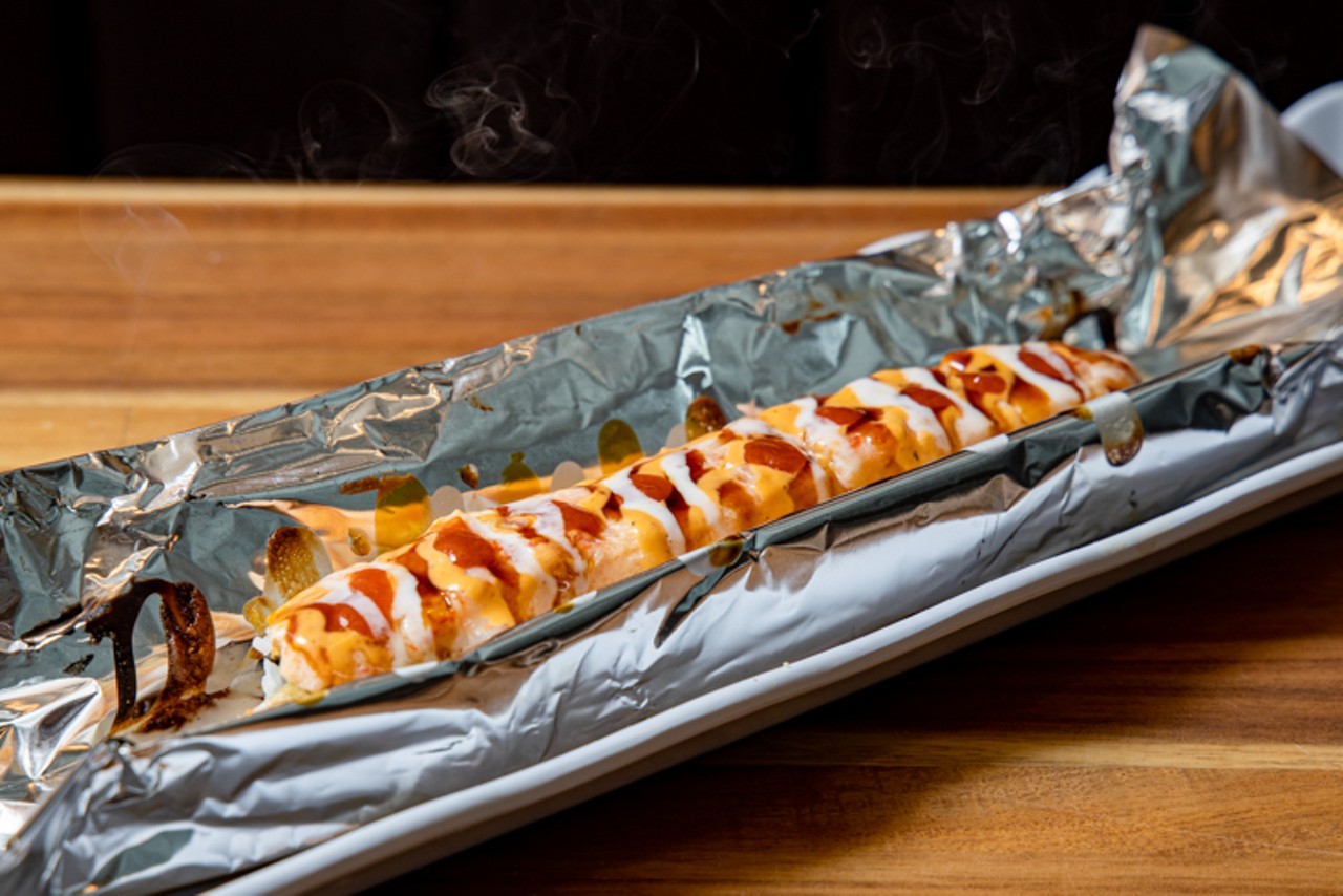 OMG sushi roll: Shrimp tempura, asparagus, mango, topped with lobster mix, furikake, finished with eel sauce and cheese puree, wrapped in foil and barbecued at table ($16)