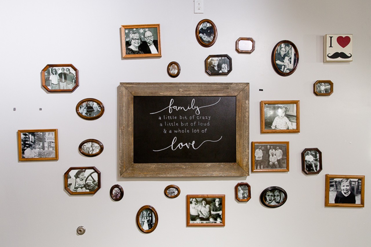 A wall of family portraits in the dining room