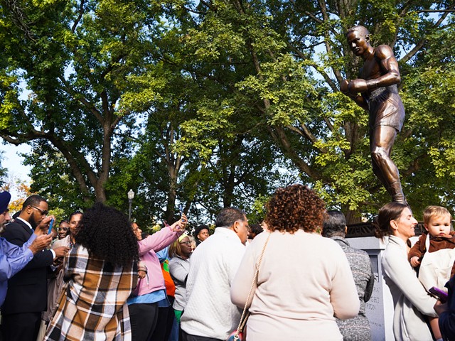 A crowd gathers around the newly unveiled Ezzard Charles statue in Ezzard Charles Park in Cincinnati's West End on Oct. 1, 2022.
