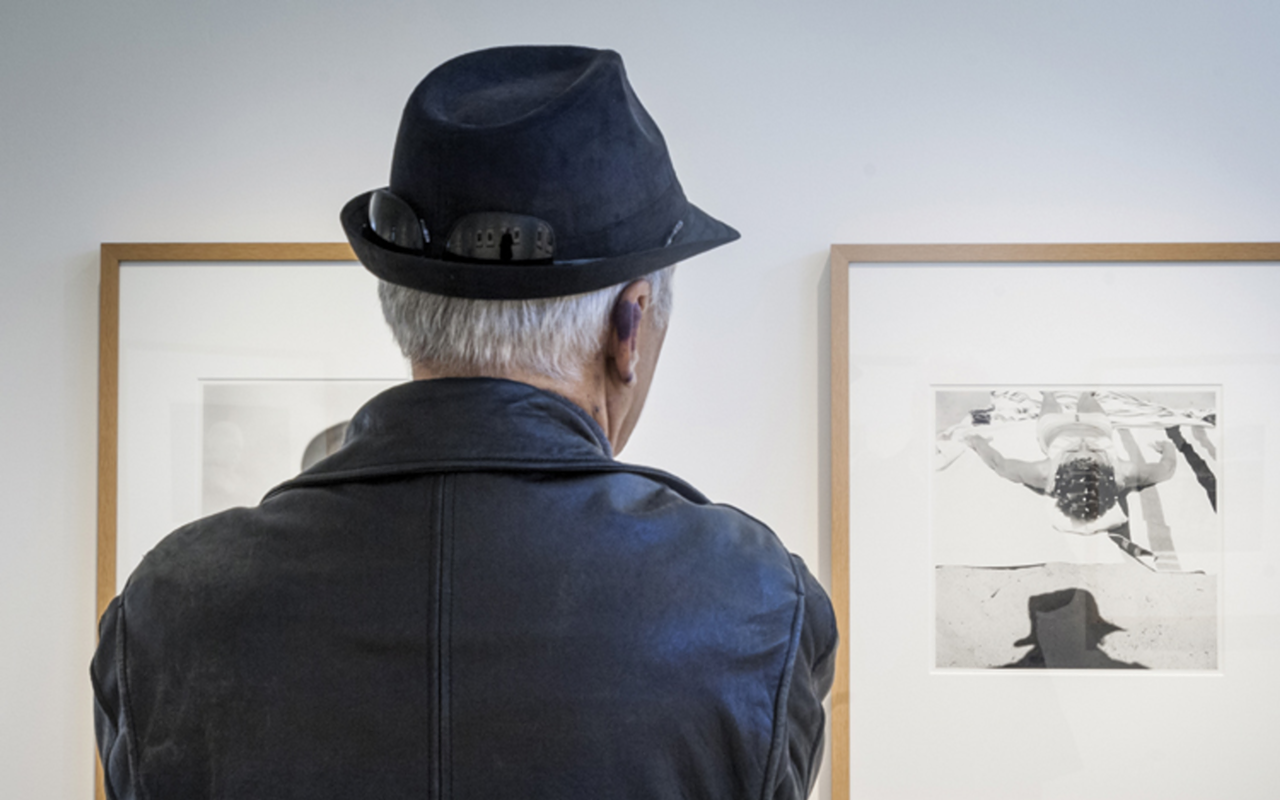 A viewer attending the 2014 FotoFocus-sponsored Vivian Maier exhibit.
