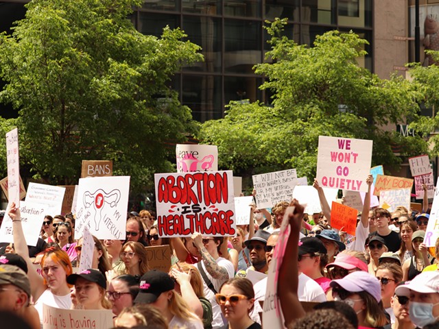 Demonstrators hold signs during Planned Parenthood's 'Bans Off Our Bodies' abortion rights rally in Cincinnati in May 2022.