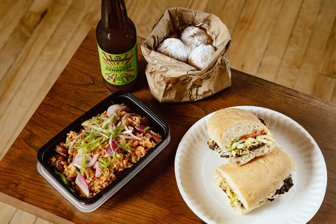 A spread of dishes from Jimmie Lou's, including a hot sausage po' boy, Cajun jambalaya and an order of beignets, with a Kombucha from Fab Ferments