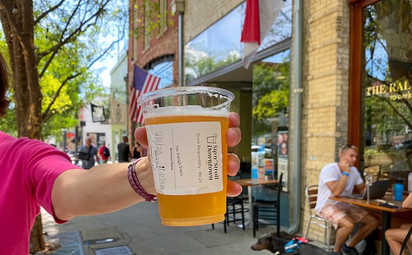 A specially marked cup shows a beer purchased in Raleigh’s Sip n’ Stroll Downtown, a special social district the North Carolina capital created last year that allows open containers of alcohol within strict bounds. States are increasingly allowing cities to create these districts in hopes of boosting — or reviving — downtown businesses.