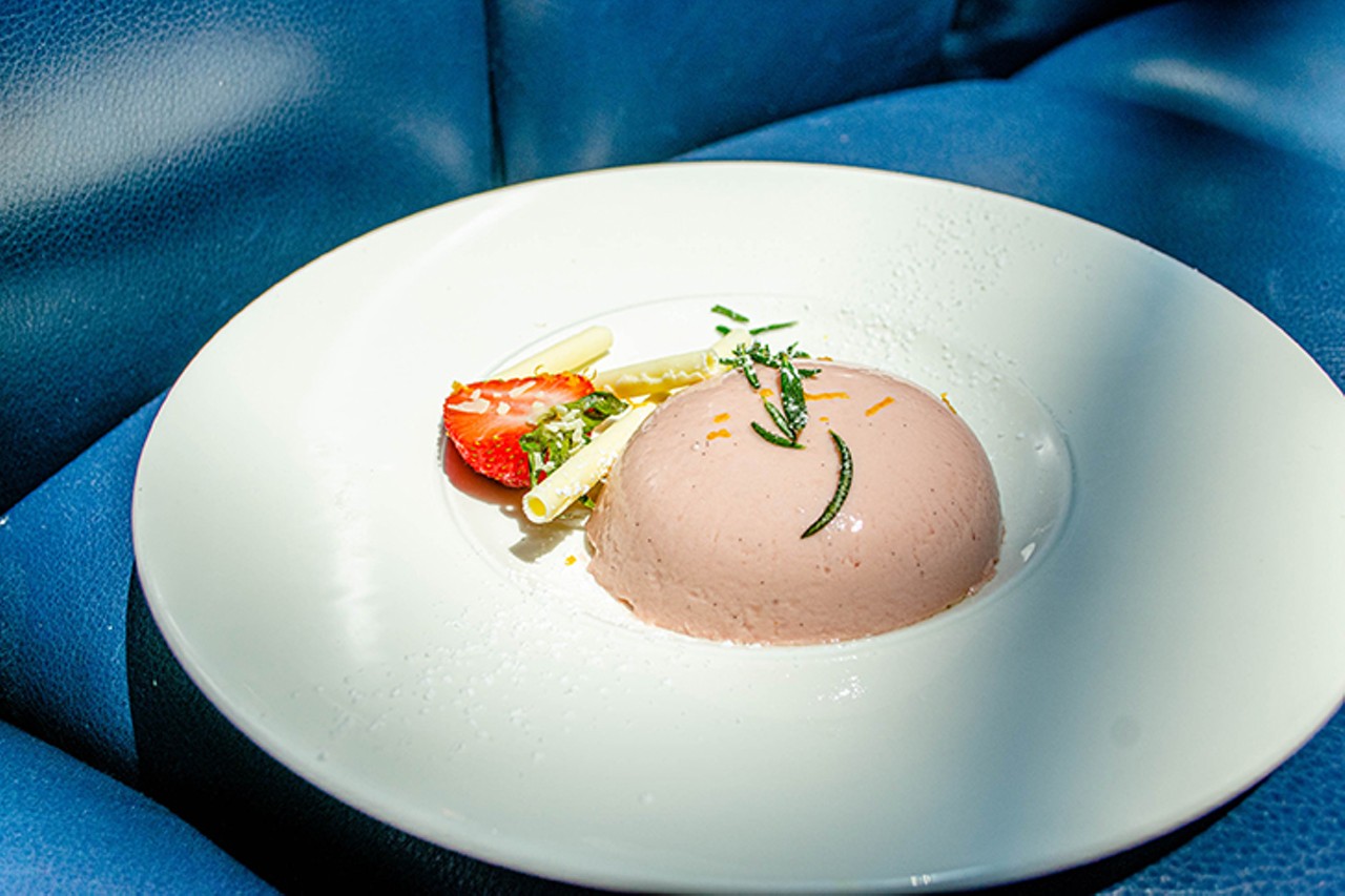 Strawberry molasses panna cotta with candied rosemary and orange zest