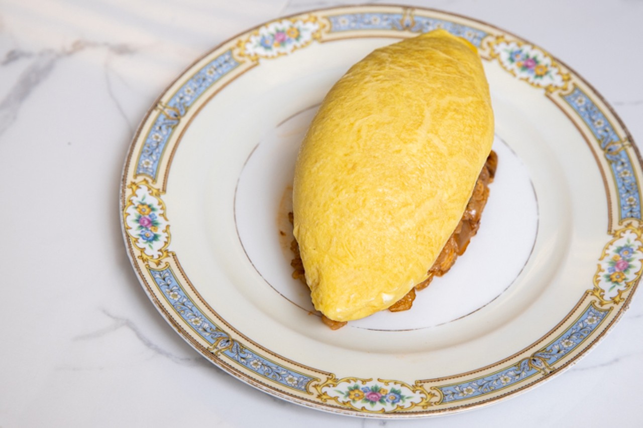Omurice &#151; a captivating piece of performance art. A specially shaped mold is filled with chicken fried rice and an eye-shaped omelet is placed on top.