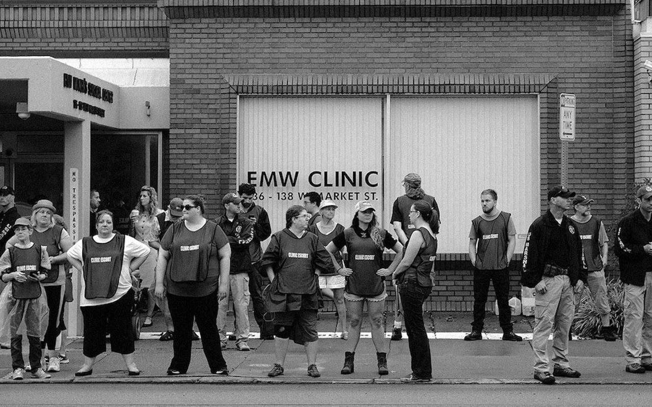 Clinic escorts stand outside of EMW Women’s Surgical Center in Louisville in 2017.