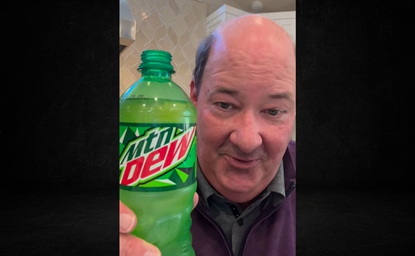 Brian Baumgartner, a.k.a. Kevin Malone from The Office, holds up a bottle of Mountain Dew.
