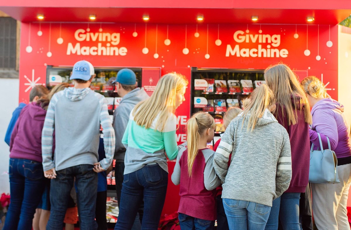 Visitors donate at Light the World Giving Machines to help those in need.