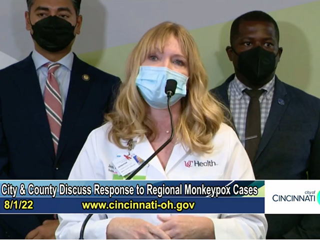 Jennifer Forrester, an infectious diseases specialist at UC Health, addresses the monkeypox outbreak with Cincinnati mayor Aftab Pureval and Cincinnati City Council member Reggie Harris in the background on Aug. 1, 2022.