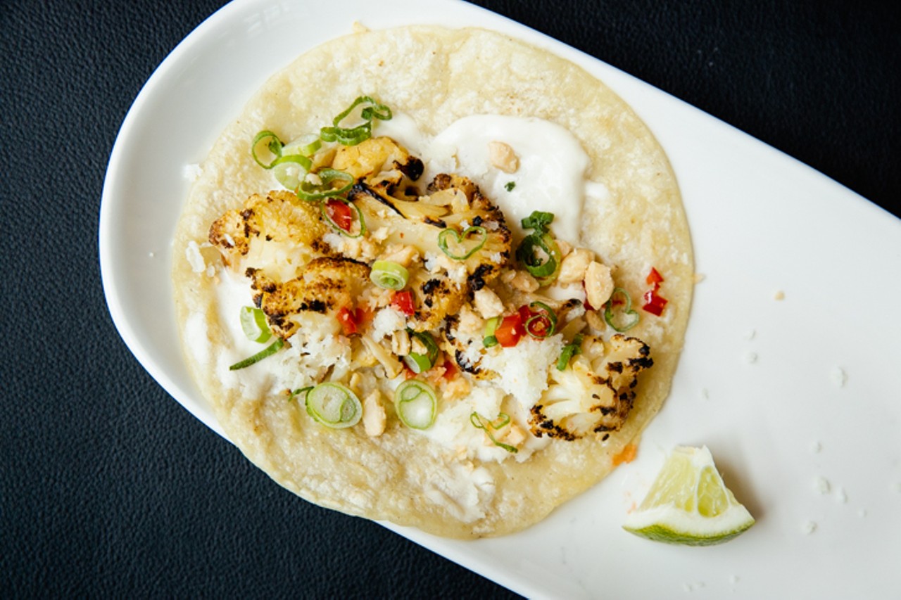 Caramelized cauliflower taco with garlic-whipped goat cheese, scallion, marcona almonds and Fresno peppers