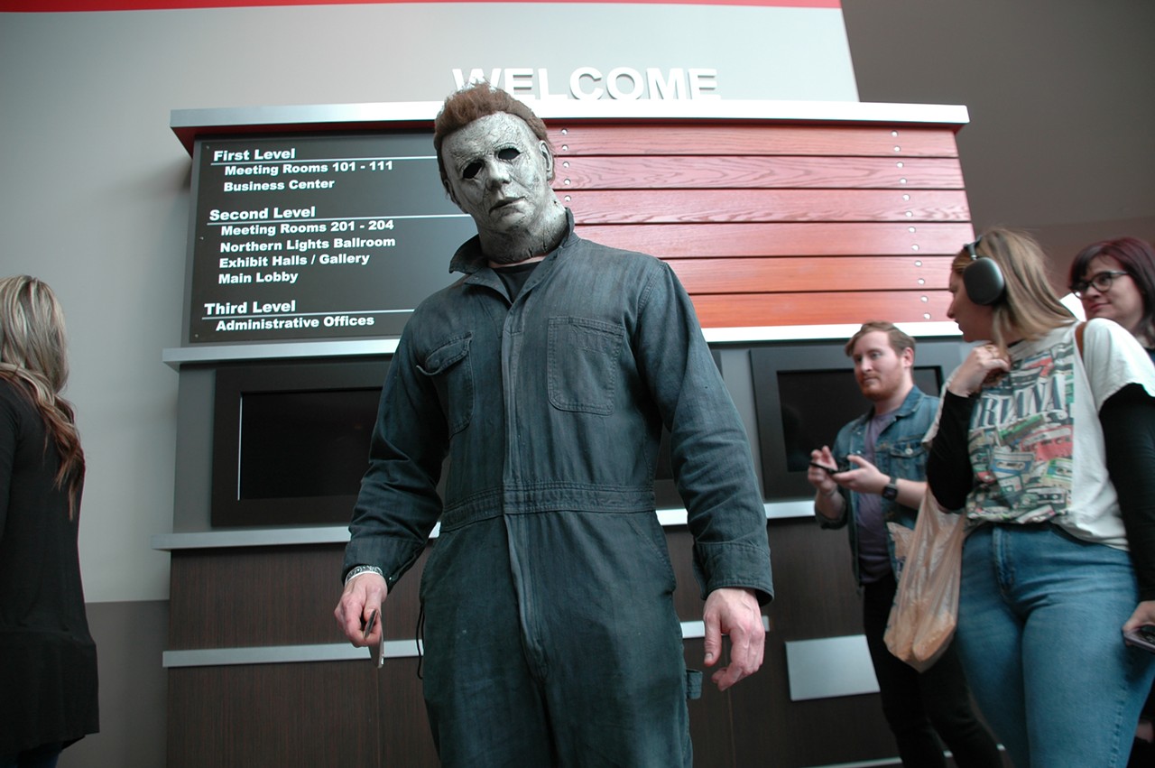 Someone dressed as Halloween’s Michael Myers welcomes fellow horror fans to the convention