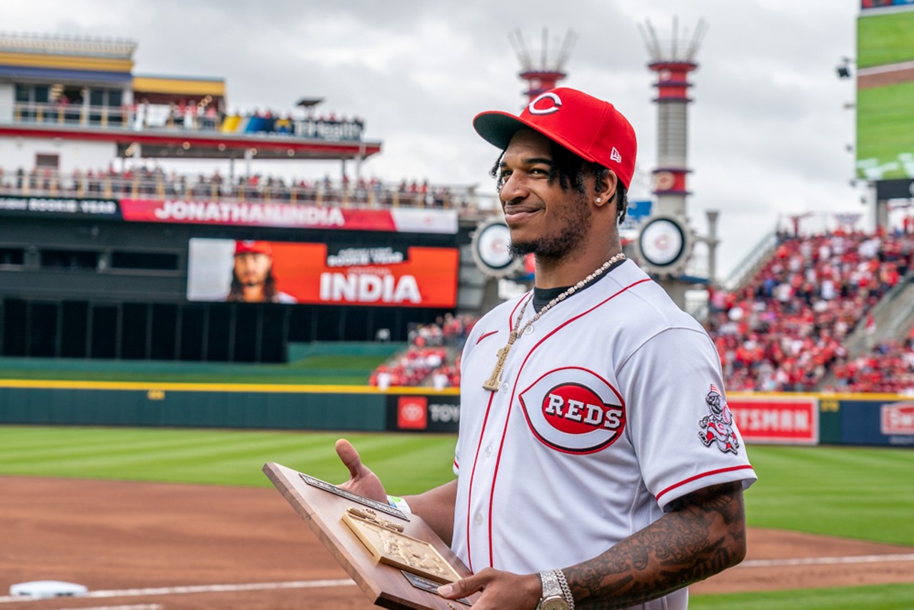 Cincinnati Reds' Jonathan India, left, receives the Major League Baseball  Rookie of the Year Award presented by Cincinnati Bengals' Ja'marr Chase  prior to a baseball between the Cleveland Guardians and the Cincinnati