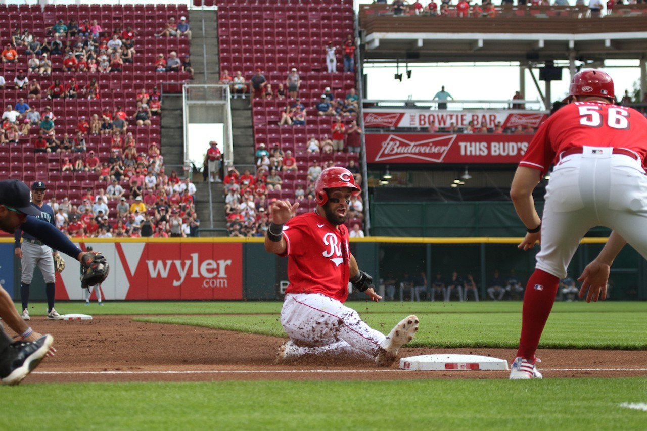 Nick Martini slides into third in the bottom of the first inning during the Cincinnati Reds' game against the Seattle Mariners on Sept. 4, 2023.
