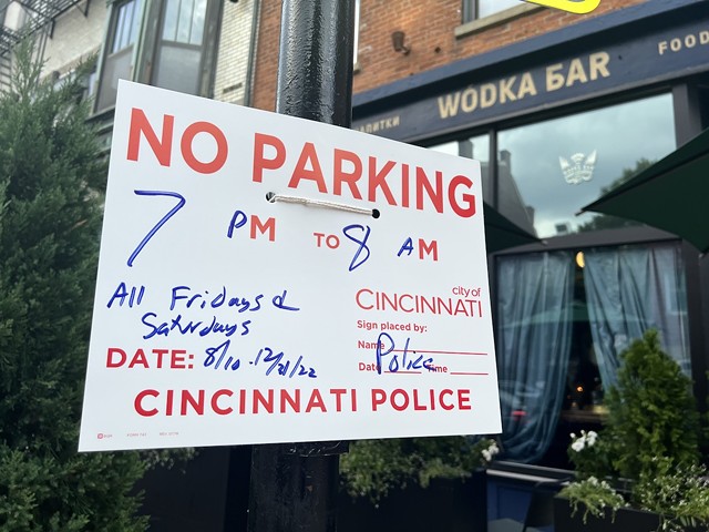 Signs going up on Aug. 11, 2022, show that police are curtailing Main Street parking in Cincinnati's Over-the-Rhine neighborhood on weekend evenings after a recent shooting.