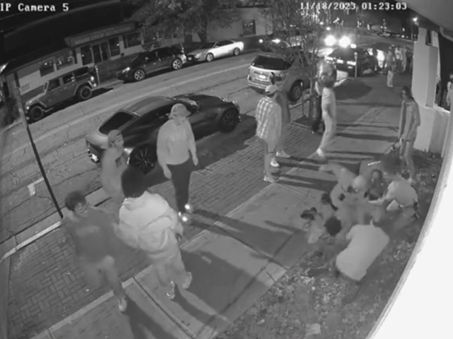 Multiple men restrain a Miami University student during an arrest outside Brick Street on Nov. 18.
