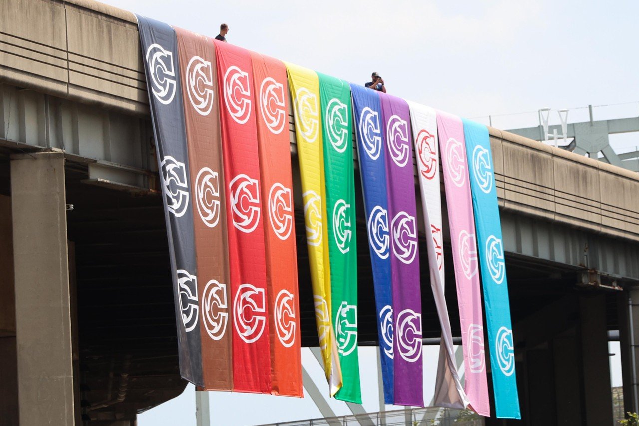 Cincinnati Cyclones hang a version of the Pride flag over the parade at Cincinnati Pride Parade on Saturday, June 22, 2024.