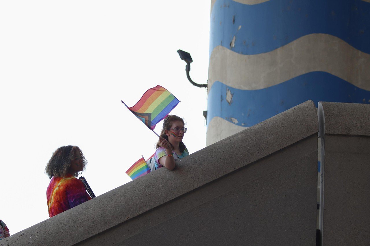 A woman waves the pride flag at the Pride festival on Saturday, June 22, 2024.