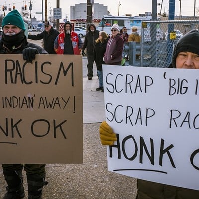Protesters in front of the "Big Indian" sign at MotorTime Auto Sales in Carthage on Jan. 15.