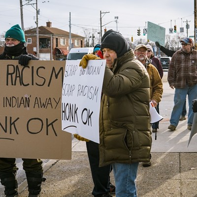 Protesters in front of the "Big Indian" sign at MotorTime Auto Sales in Carthage on Jan. 15.