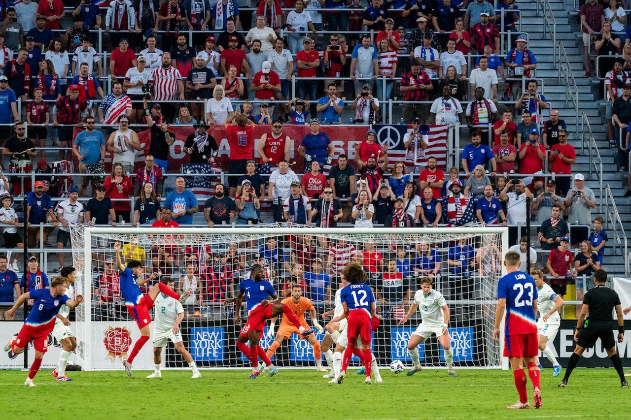 USA forwards attempt to settle ball inside goal box.