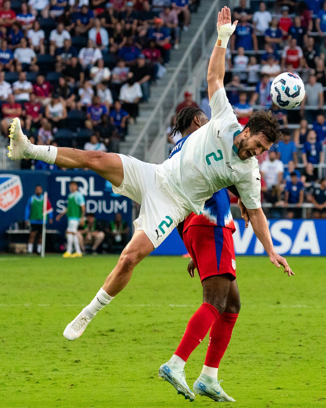 New Zeland player loses the battle for a head ball.