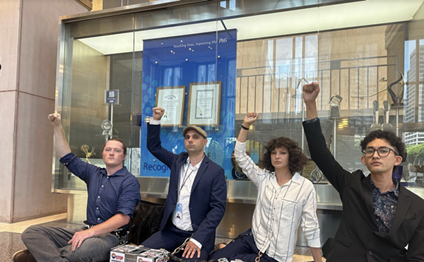 Four protesters were arrested after being asked to leave P&G headquarters in Cincinnati.