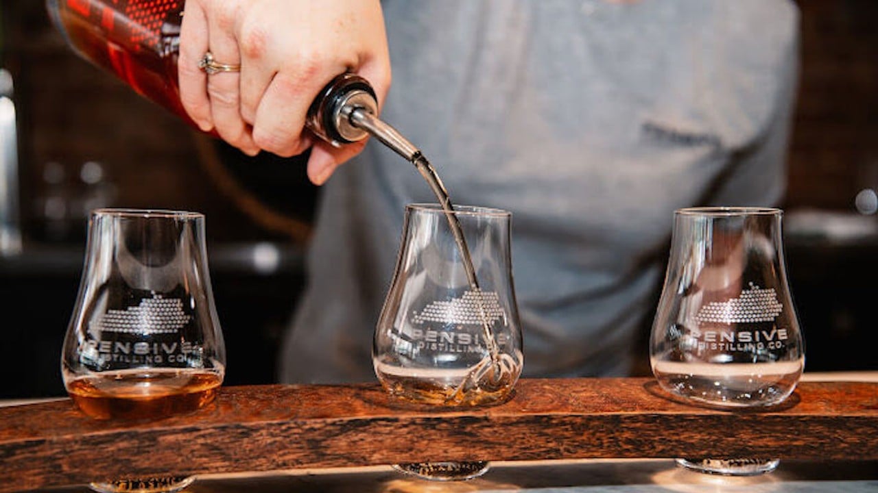 Bourbon gets poured into a glass.