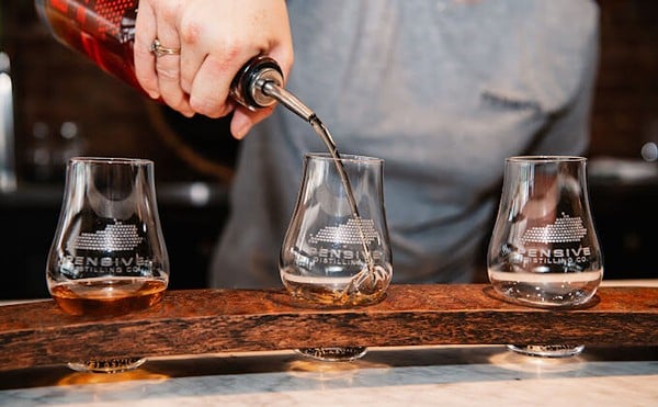 Bourbon gets poured into a glass.