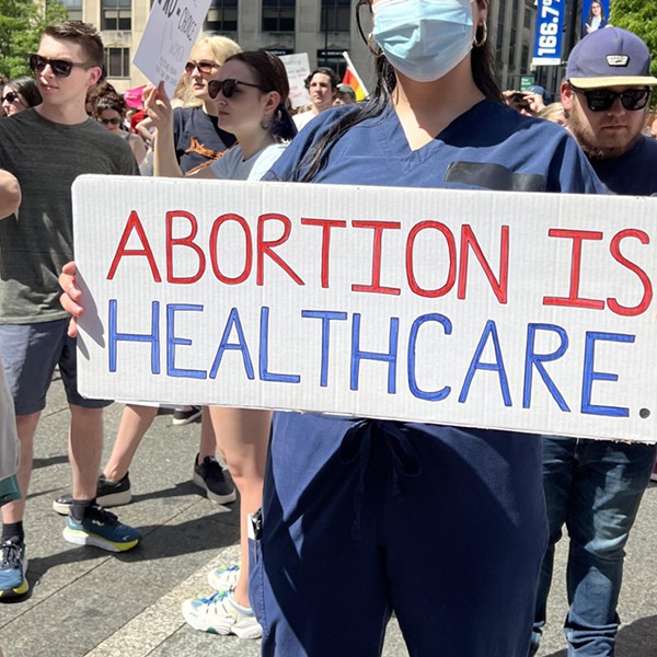 A nurse holds a sign in support of abortion access at a Planned Parenthood rally in Downtown Cincinnati on May 15, 2022.