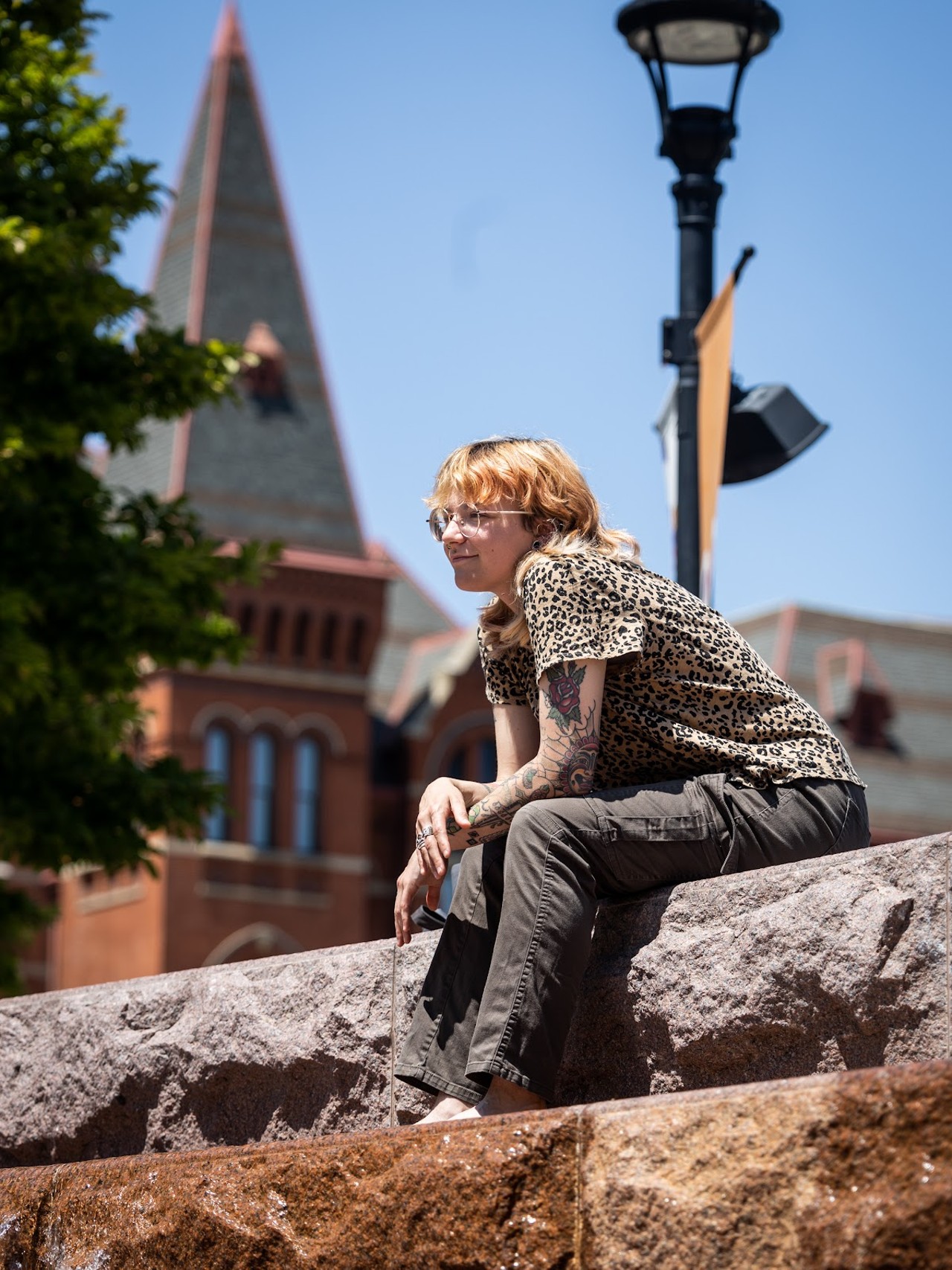 Milo, a local resident, sits atop the waterfall staircase at Washington Park. Milo is an artist in Cincinnati and was spending their free time before work basking in the sun and soaking their feet in the fountain. Milo works at the Contemporary Art Museum as a receptionist. “I didn’t really have a plan before I got here. I just wandered up and saw that they turned the fountains on," they said.