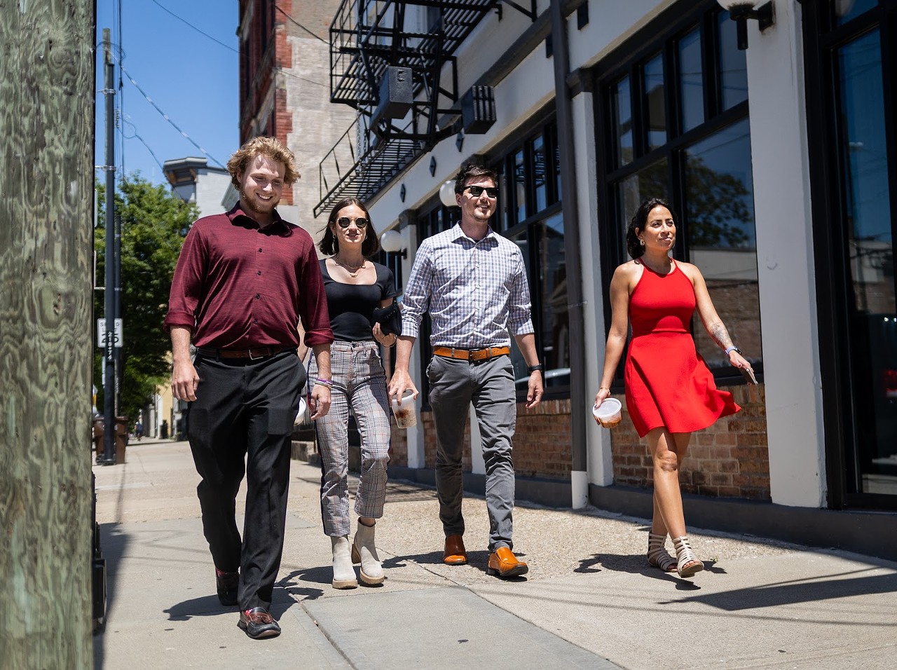 A group of information technology workers at Resolvit, LLC, walk back to work near Washington Park. Only one of the workers is originally from the city (far left), whereas two other members (middle right and far right) have moved here for work and the last member (middle left) is visiting for work.