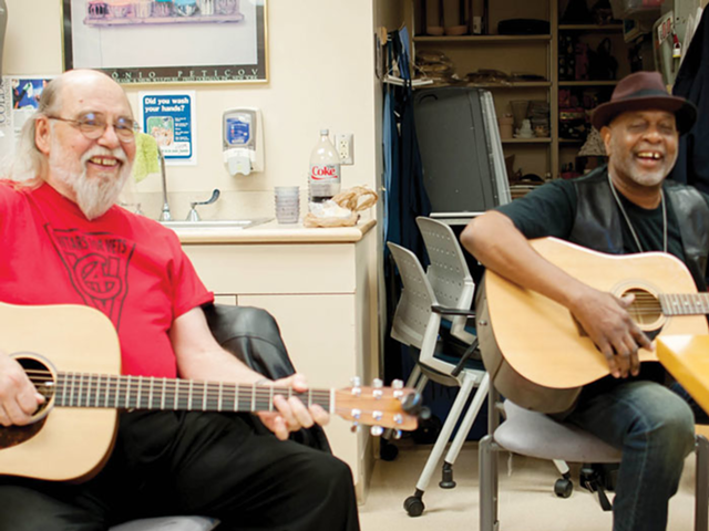 Dick Buchholz, a local Guitars for Vets instructor, jams with Air Force veteran Jimmy Walton.