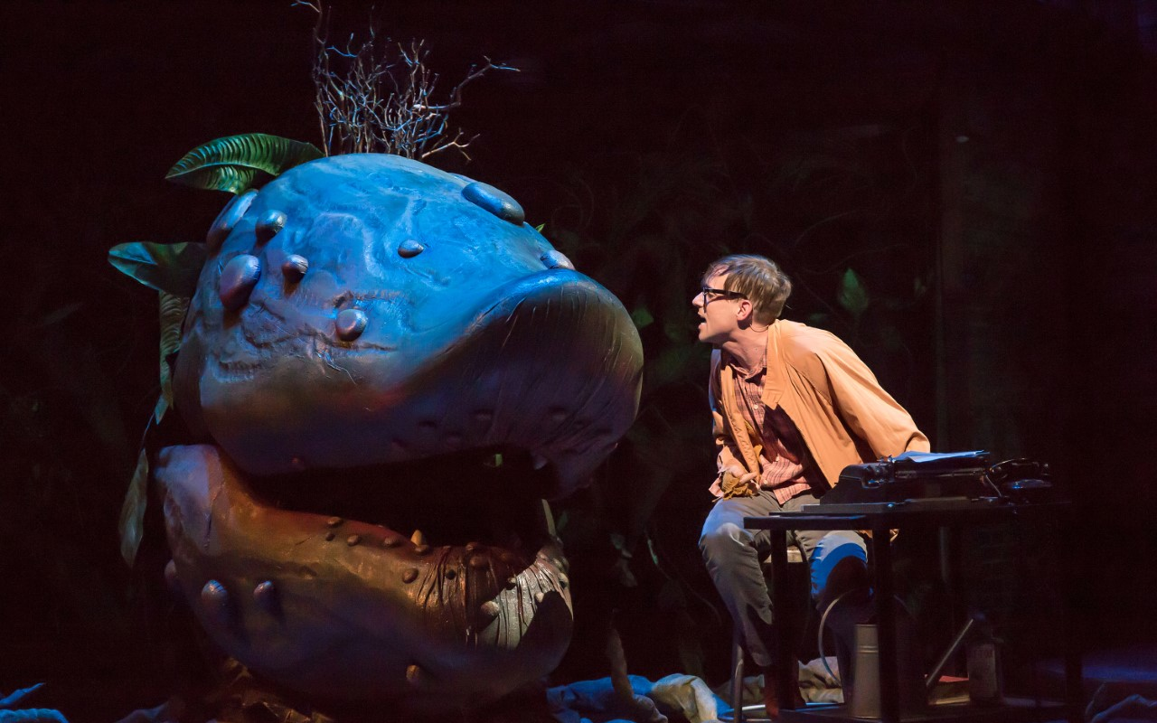 Nick Cearley as Seymour with his carnivorous plant, Audrey II, in "Little Shop of Horrors"