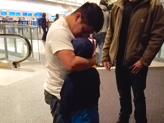 Benjamin Yat-Xicol embraces his son Danny before the two are escorted by ICE officers to an airplane bound for Guatemala.