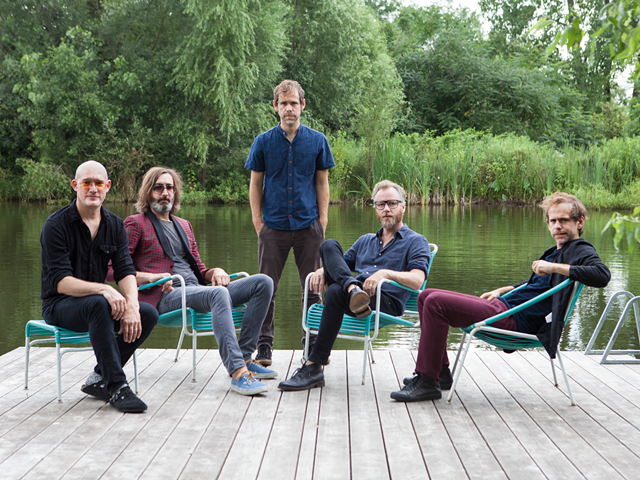 The National with twin brothers Aaron and Bryce Dessner (middle and seated, far right)