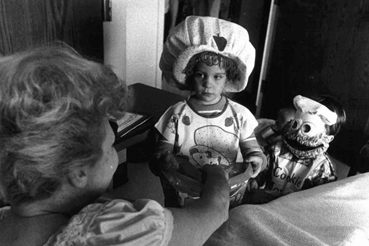Covington, 1981
"Mary Carpenter giving treats to Allison Schnider (5) and Waverly Marcum (3) with kids from Pediatrics going through Booth Hospital trick or treating."