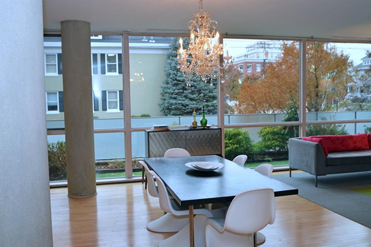 Dining area overlooks the garden through floor-to-ceiling windows.