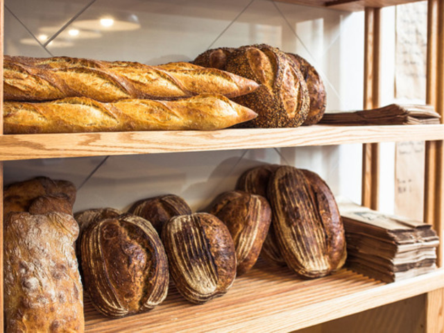 Bread loaves and baguettes on the shelves at Allez Bakery in Over-the-Rhine.