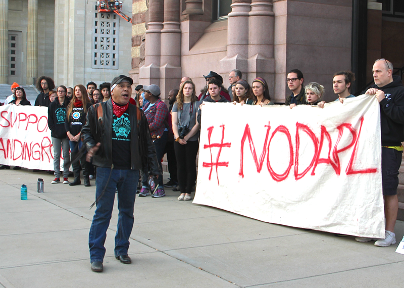 Local activist Jheri Neri speaks at a rally at Cincinnati City Hall against the Dakota Access Pipeline. - NICK SWARTSELL