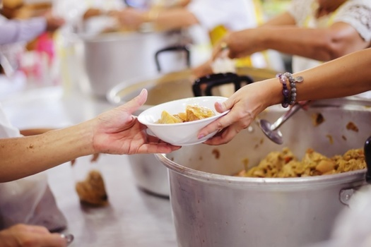 Volunteering at a soup kitchen or homeless shelter is one way to honor Dr. King's legacy of service. - Photo: Adobe Stock